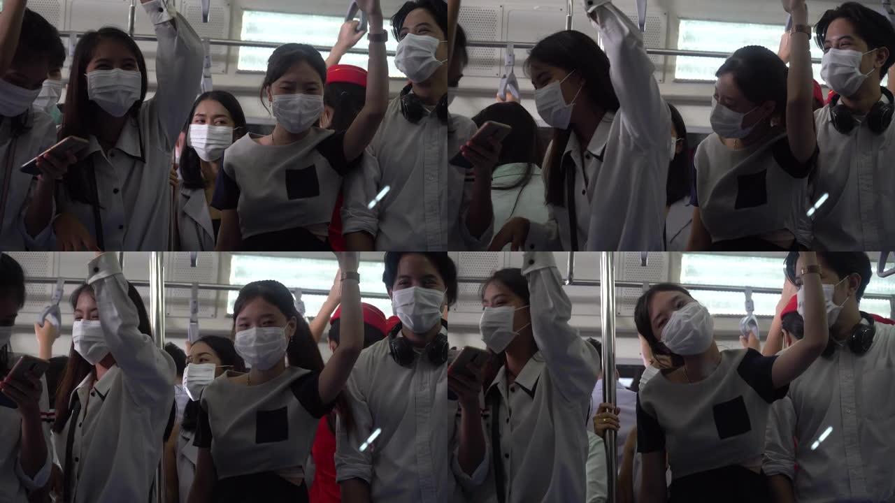 戴着外科口罩的亚洲人站在一起挤在地铁里没有社交距离不怕感染冠状病毒。在新型冠状病毒肺炎大流行中，公共