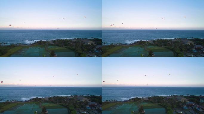 风筝在日落时在海洋附近飞翔鸟瞰图