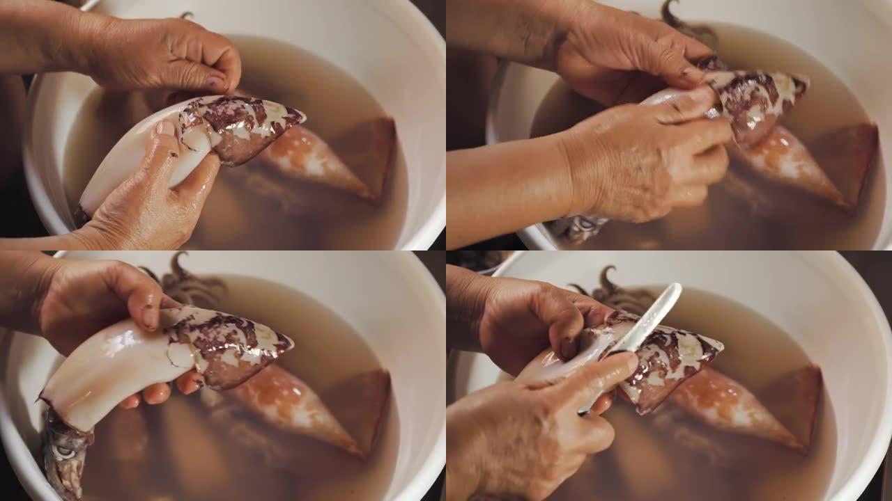 鱿鱼被一位老太太的手剥皮了。洗一下。宏观拍摄。用传统方式准备海鲜餐。