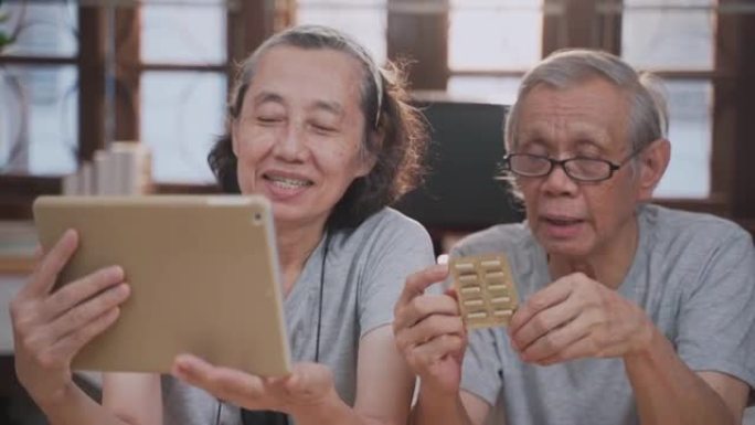 在远程医疗预约期间，使用数字平板电脑与女医生进行亚洲老年家庭的远程医疗