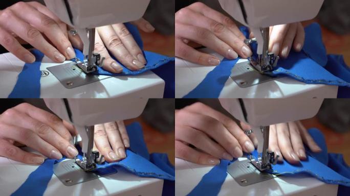 年轻女子在工作场所用现代机床缝制蓝色织物衣服的包边