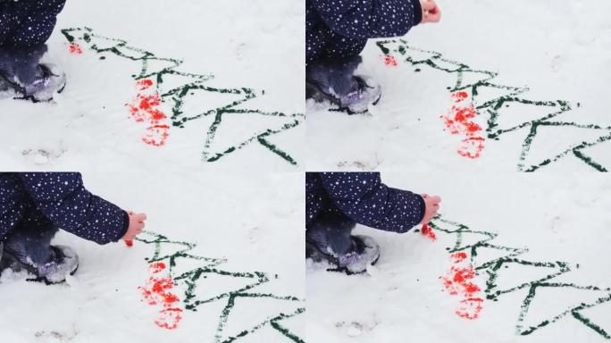 冬季乐趣。孩子在雪地里用颜料画画。特写。在雪地上画画。在户外下雪的冬天玩得开心
