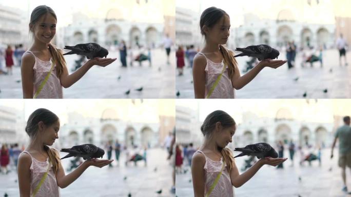 在意大利威尼斯的圣马可广场上喂鸽子的孩子