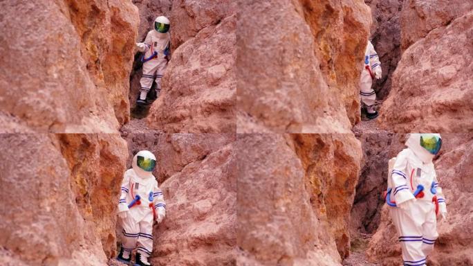 穿着太空服的女人从洞穴里走槽，看到在沙漠地区探索火星的新方法，梦想着人类能遇到水源，生命。