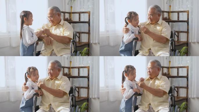 老人孤独地坐在轮椅上生病和孙女奔跑抱着纸鸟玩耍