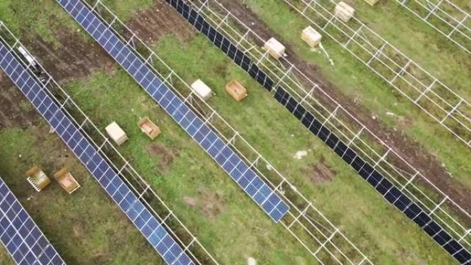 绿地上正在建设的太阳能发电厂的鸟瞰图。清洁生态能源生产用电板的组装。