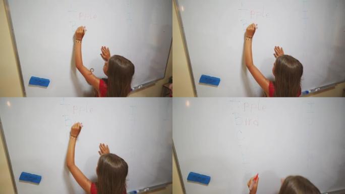 年轻的小学生在黑板上写答案