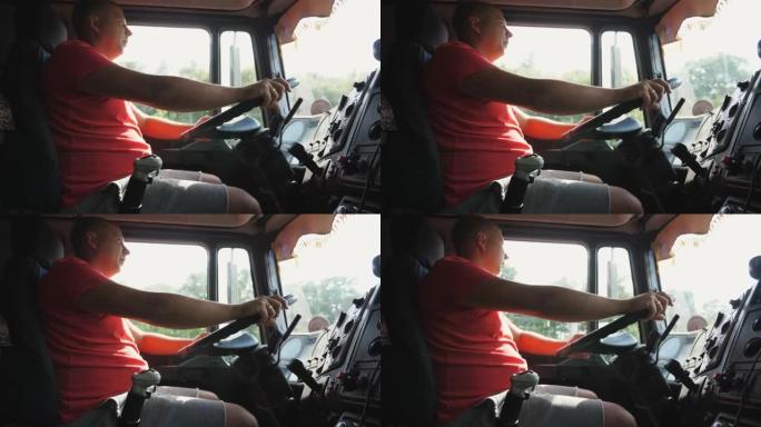 卡车司机将手臂握在方向盘上，并控制汽车驶向目的地。卡车司机在乡下操作卡车。男子在乡间道开车。物流运输