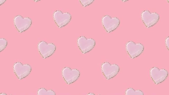 无缝循环动画，心形饼干图案由粉彩背景上的粉色釉装饰，对角线运动