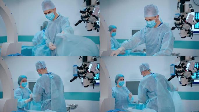 现代手术室的医学专家。外科医生和护士在手术前准备工作场所。医生用新材料覆盖病人。