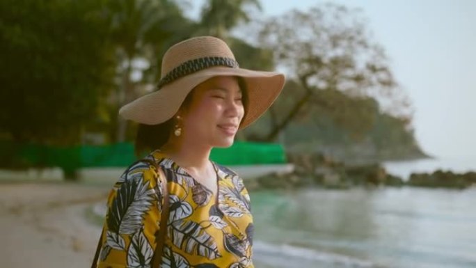 幸福蛤蜊亚洲女性旅行者休闲布带帽子散步享受沙滩日落moent沙滩海洋背景旅游旅游概念