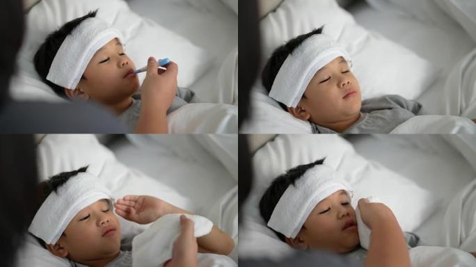 亚洲孩子对体温计和母亲感到恶心。照顾和生病的概念