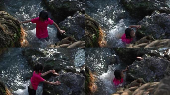儿童在旅游暑假山上的瀑布中玩耍，亚洲快乐的儿童在大自然中旅行