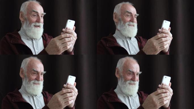 快乐的老人在智能手机上阅读信息，好消息，投注应用程序