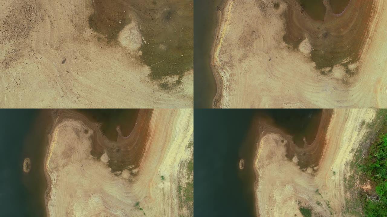 一个干燥的湖泊的鸟瞰图很久以前一直干燥的湖泊深处的地面上有许多裂缝。令人惊叹的自然纹理无人机摄像机视