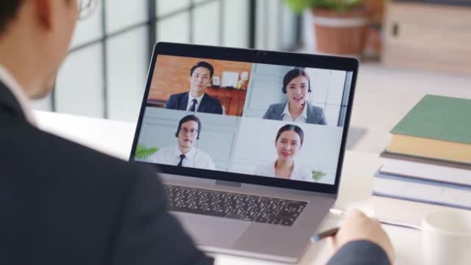 年轻的亚洲商人在家工作，与同事进行虚拟视频会议商务人员，在线工作，在家办公室进行视频通话