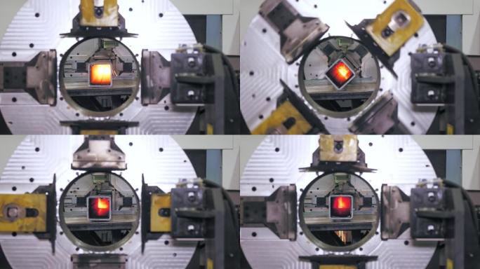 金属管道激光切割机。特写。现代数控光纤激光器切割方形金属管。切割过程中，明亮的燃烧火花从激光束中飞出