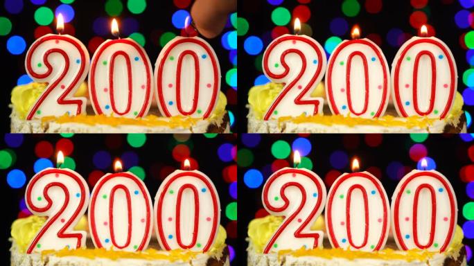 200号生日快乐蛋糕与燃烧的蜡烛顶。