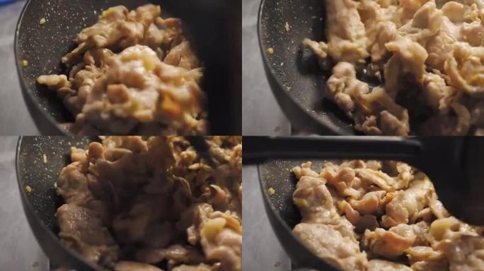 猪肉在平底锅上炒。宏观倾斜镜头。准备制作炒菜菜单。