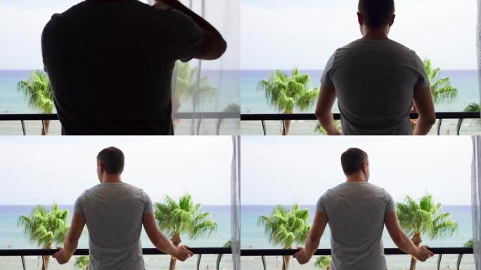 度假的男人打开窗帘，走到阳台上，从露台上欣赏地中海海景