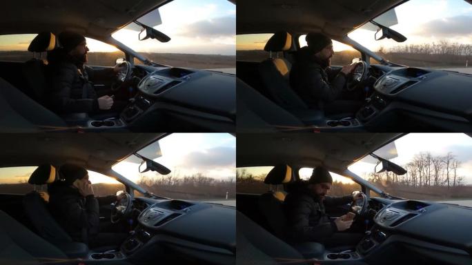 司机。一个英俊的年轻人驾驶汽车，由安装在汽车上的GoPro摄像机拍摄。日落时开车。