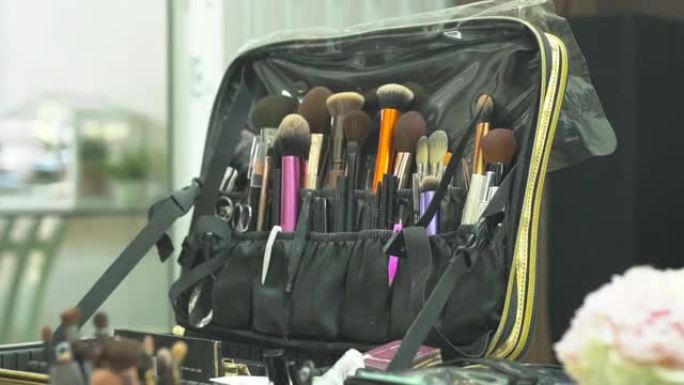 化妆师正在选择设备，化妆工具刷粉大小不同。