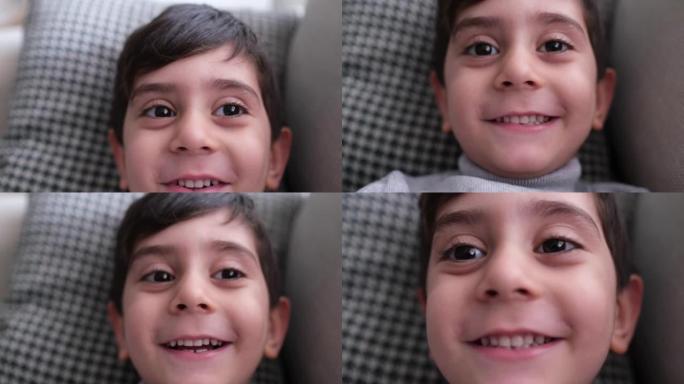 微笑可爱的男孩拍照和facetime聊天。