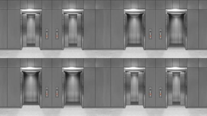 滑动钢门电梯打开，显示电梯内部。灰色墙壁的办公楼。