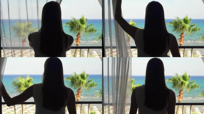 度假的女人打开窗帘，走到阳台上，从露台上欣赏地中海海景