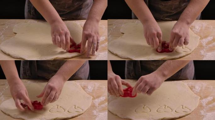 女人的面包师用烤锡制作饼干。烘焙、烹饪和糕点制作概念素材。特写。慢动作
