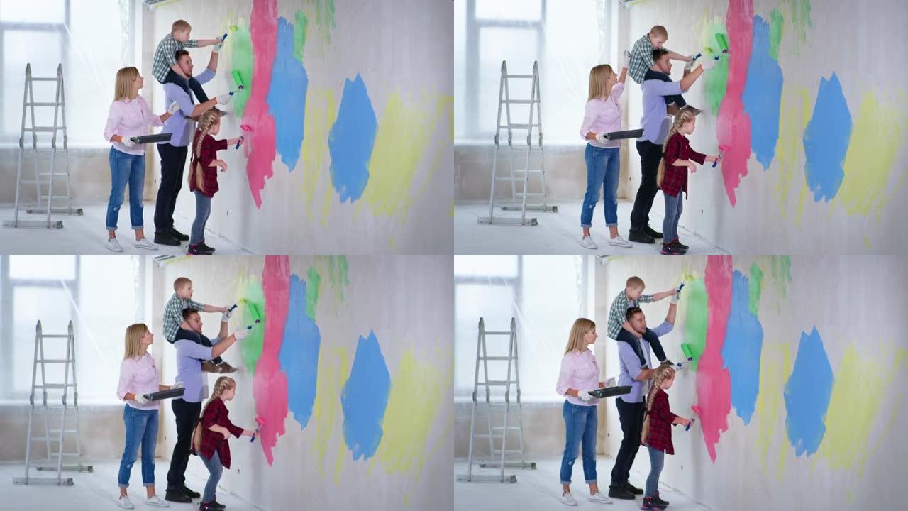 有创意的家庭，父亲脖子上有患有唐氏综合症的男孩，姐姐正在新公寓里完成工作，并在墙壁上涂漆，用滚筒彩色