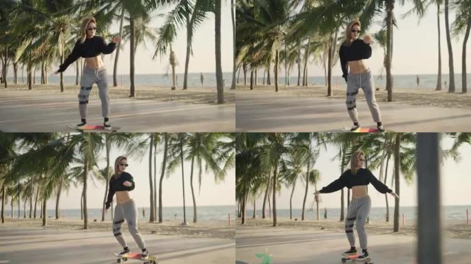4k视频慢动作，跟随侧面摄像机视图。日落时分，一名戴着眼镜的亚洲妇女在海滩附近的椰子树公园玩冲浪滑板