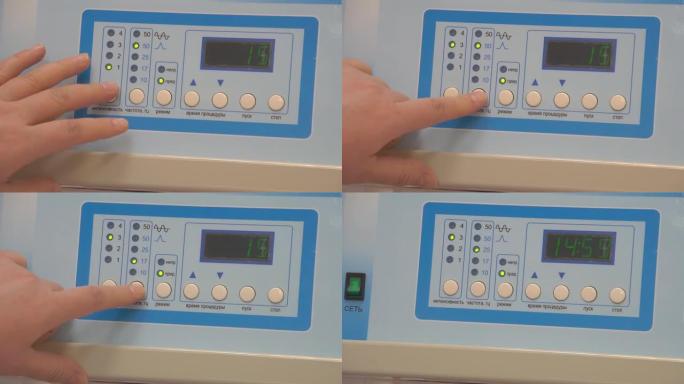 医生的手在医疗设备的仪表板上的特写。医生的特写镜头包括医疗设备。