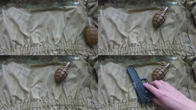 一名士兵在军装上放了一枚手榴弹和一把手枪