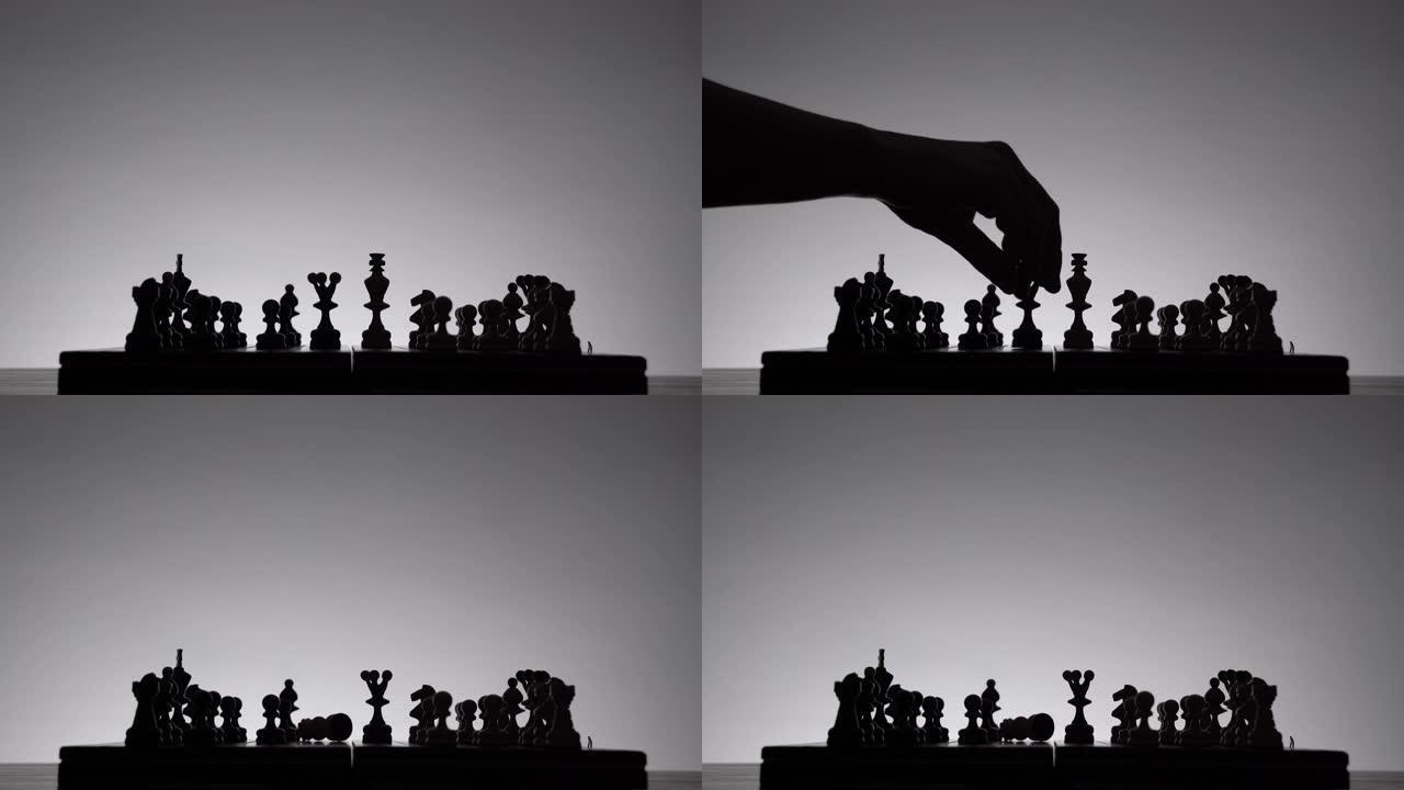 象棋游戏。白色背景上有棋子剪影的棋盘。经营理念和竞争与战略理念。黑白经典艺术照片。