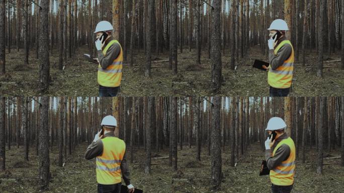 工程师检查员在伐木前通过电话谈论森林的情况。头目头目戴着头盔和背心的手势挥舞着双手，训斥或责骂下属。