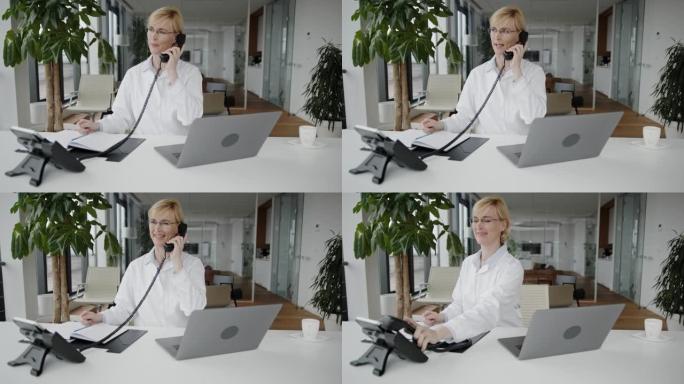 在办公室使用固定电话的女医生
