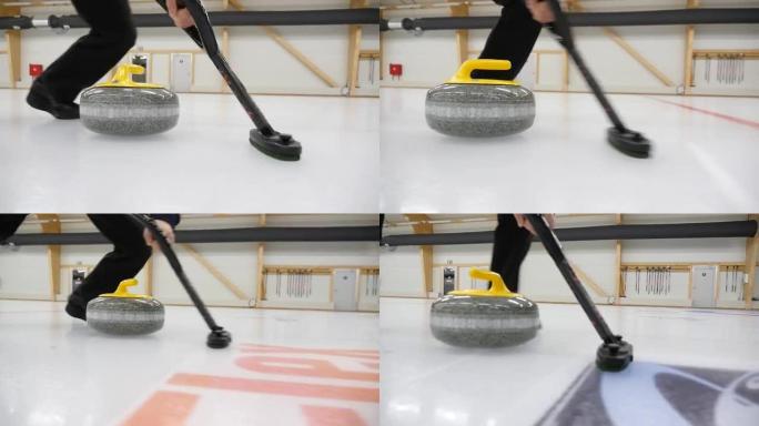 冰壶比赛。冰壶正在冰场上玩冰壶游戏。花岗岩石头在冰盖上滑动。