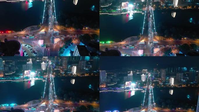夜光海南岛三亚市交通十字路口河边空中俯视图4k中国