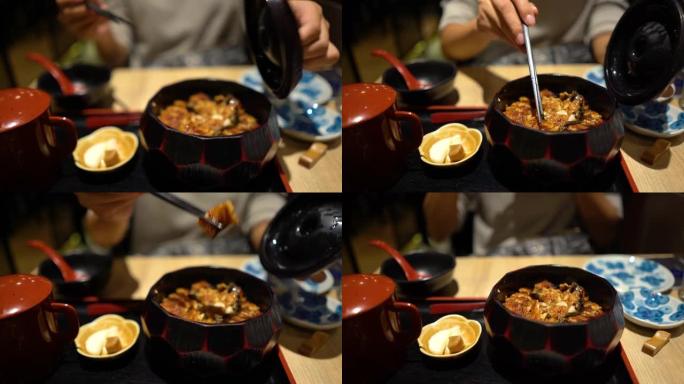 亚洲妇女在日本餐馆吃一顿便餐Hitsumabushi