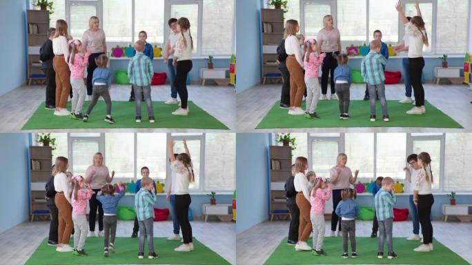 孩子们围成一个圆圈，一边玩耍一边听老师说话，不同的男孩和女孩积极地在一起度过时间