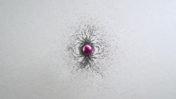 物体周围磁场的例子，带有粉红色的磁铁和铁屑