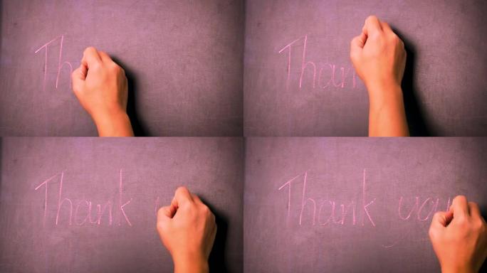 一个女人拿着粉笔在黑板上写下 “谢谢”。