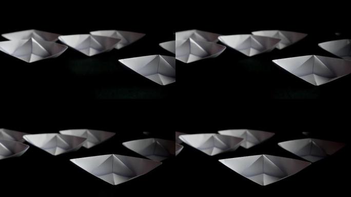 黑色背景上的papper折纸船