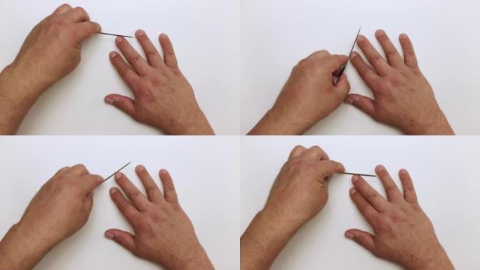 男人的手用金属锉轻轻地加工中指上的指甲。