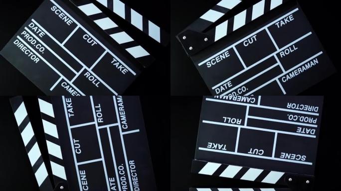 黑色背景上打开电影拍板或拍板的旋转。