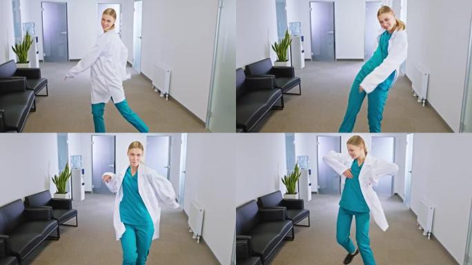 心情愉快的女医生在现代医院走廊中间跳舞，激动地在镜头前露出灿烂的笑容