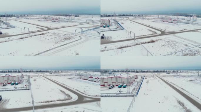 电影空中无人机镜头。在油气田用油和水飞越储层。冬季的西伯利亚针叶林。直升机飞行