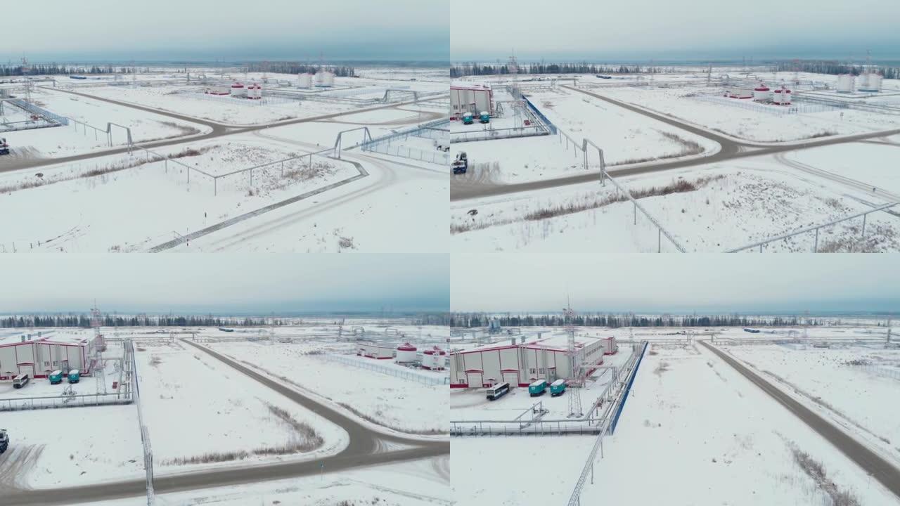 电影空中无人机镜头。在油气田用油和水飞越储层。冬季的西伯利亚针叶林。直升机飞行