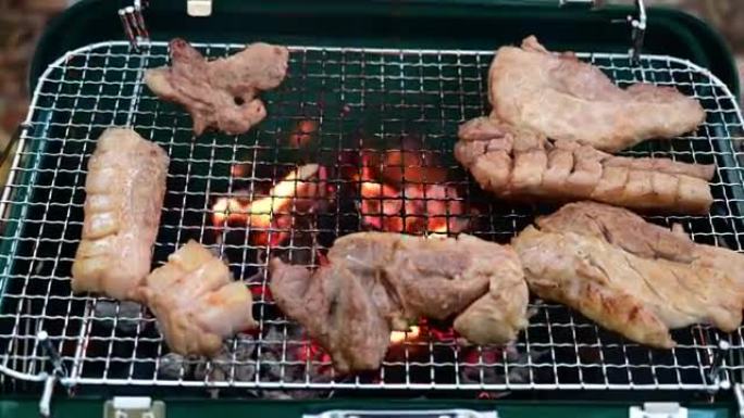 夏令营旅行营地的4k烧烤烧烤。火焰在烧烤篝火晚会上烧烤牛排。